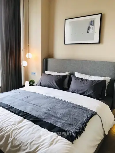 Modern bedroom with stylish decor and cozy lighting in a contemporary apartment.