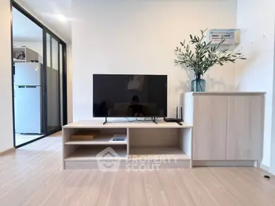 Modern living room with sleek TV stand and stylish decor in a contemporary apartment.