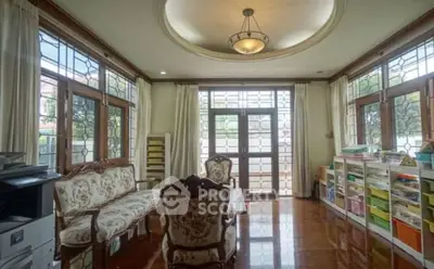 Elegant living room with vintage furniture and large windows