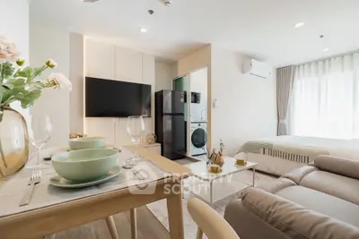 Modern studio apartment with open layout, featuring a cozy living area, dining space, and compact kitchen.
