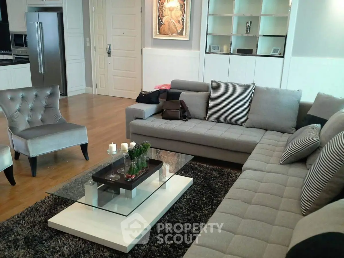 Luxurious modern living room with stylish gray furniture and elegant decor.