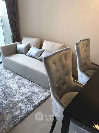 Elegant living room with plush sofa and stylish chairs, perfect for modern comfort.