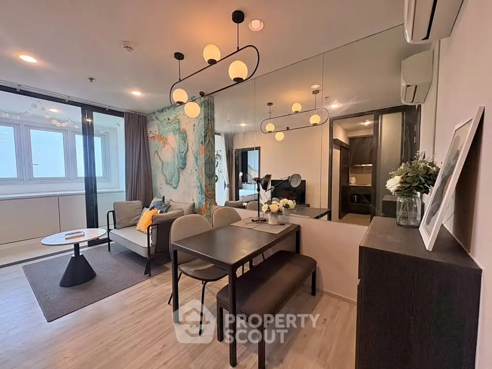 Modern living room with stylish dining area and elegant lighting in a contemporary apartment.