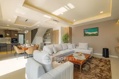 Luxurious open-plan living room with modern decor and dining area, perfect for entertaining.