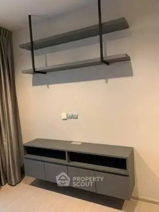 Modern minimalist living room with sleek wall-mounted shelves and cabinets.