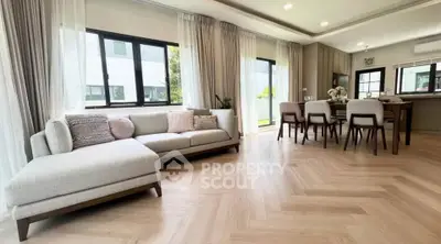 Spacious modern living room with elegant dining area and natural light