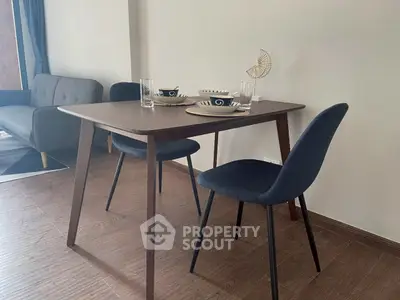 Modern dining area with stylish table and chairs in cozy living space.