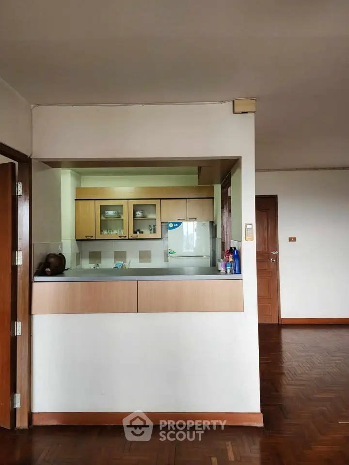 Spacious open kitchen with wooden cabinetry and parquet flooring