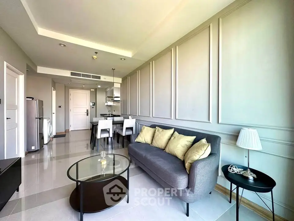 Modern living room with elegant decor and open kitchen layout