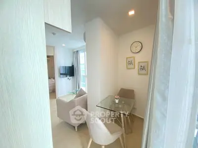 Modern living room with glass dining table and cozy seating area