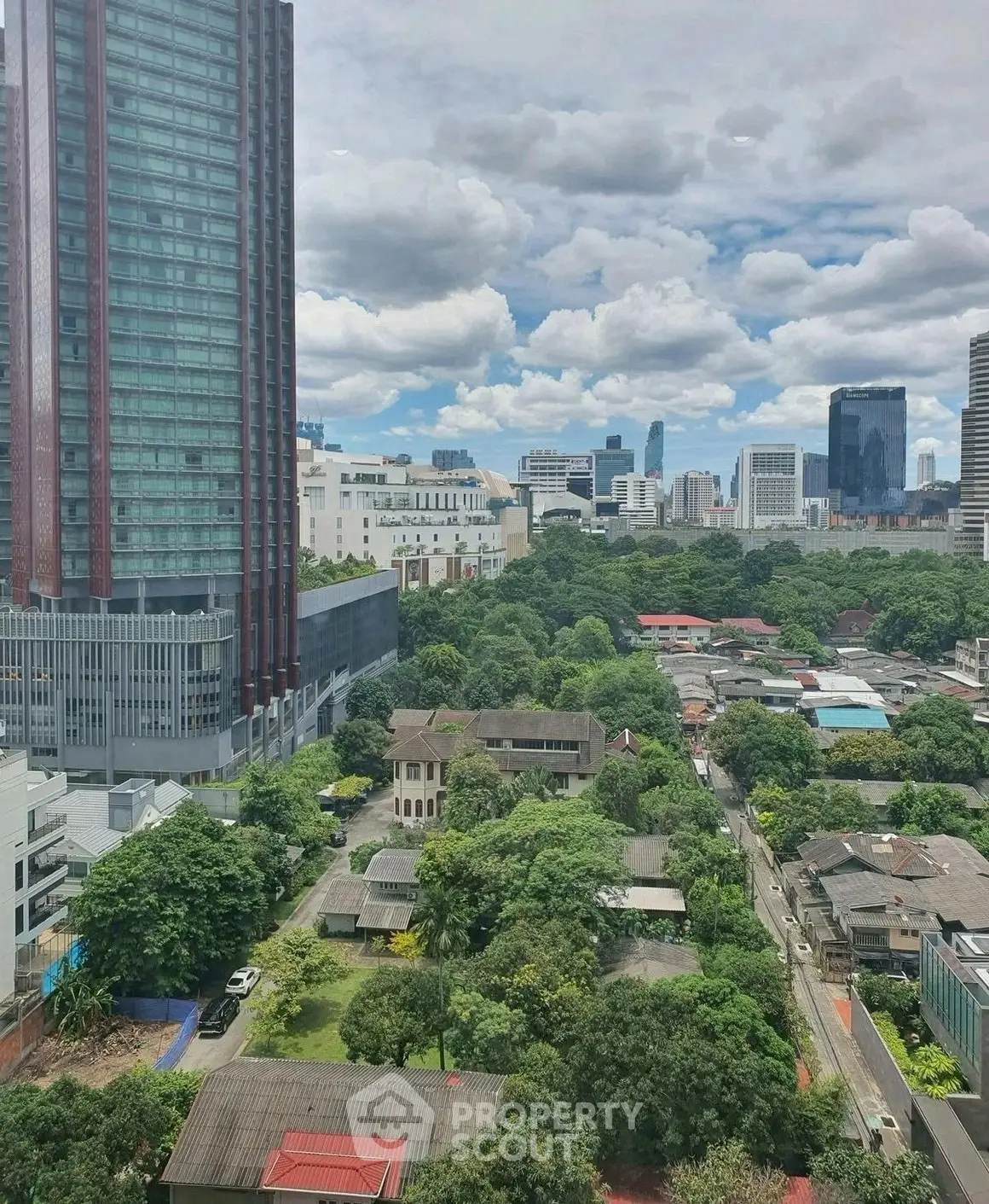 Stunning cityscape view with lush greenery and modern skyscrapers, perfect for urban living enthusiasts.