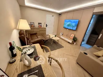 Modern living room with stylish decor, cozy seating, and mounted TV, perfect for relaxation and entertainment.