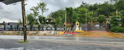 Charming residential entrance with decorative fence and lush greenery