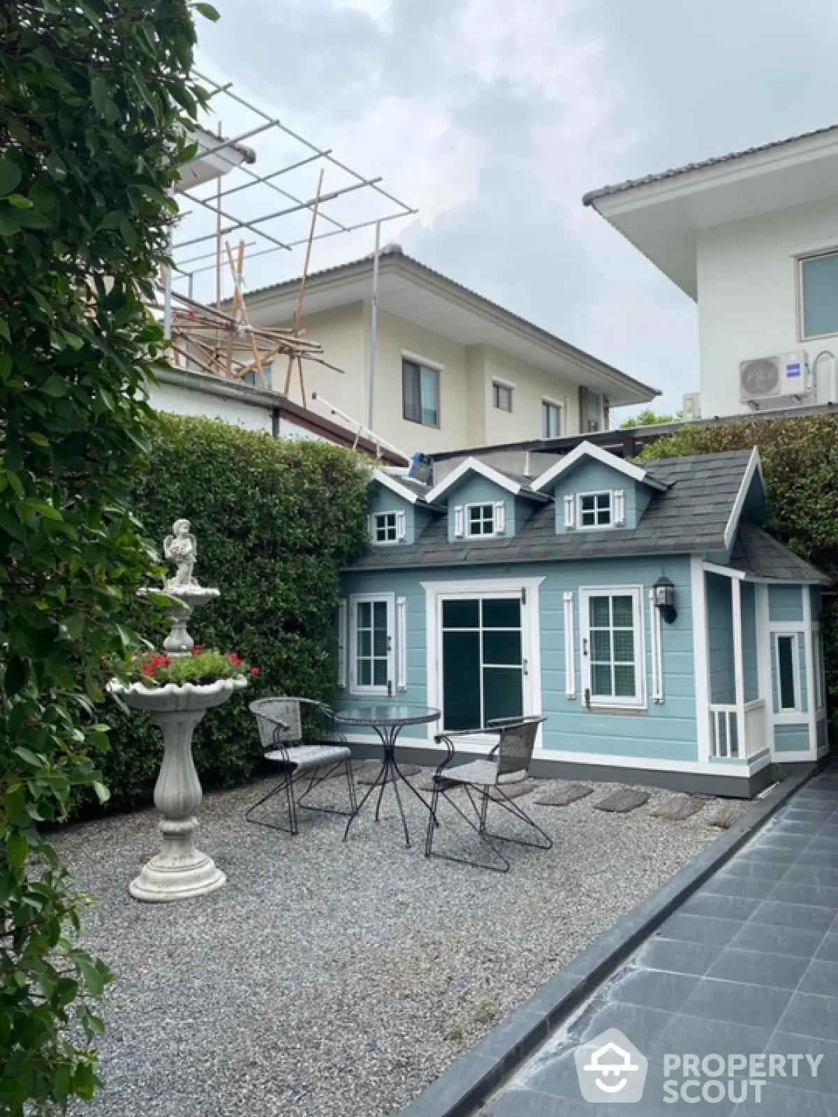 Charming garden with a quaint playhouse and outdoor seating area