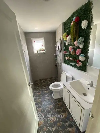 Charming bathroom with unique wall decor and modern fixtures