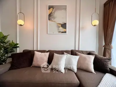 Elegant living room with plush brown sofa and modern lighting