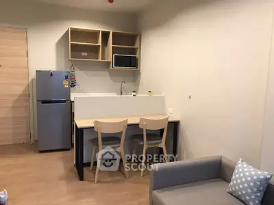 Modern compact kitchen with dining area in cozy apartment