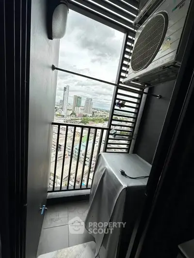 High-rise balcony with city view and air conditioning unit, perfect for urban living.