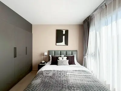 Modern bedroom with stylish decor and large window for natural light