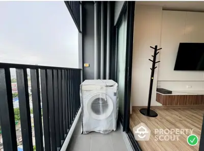 Modern balcony with washing machine and city view, perfect for urban living.