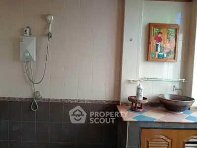 Charming bathroom with unique sink and shower setup, perfect for a cozy home.