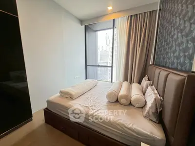 Modern bedroom with city view, featuring sleek design and large windows for natural light.