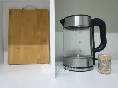 Modern kitchen shelf with electric kettle and wooden cutting board