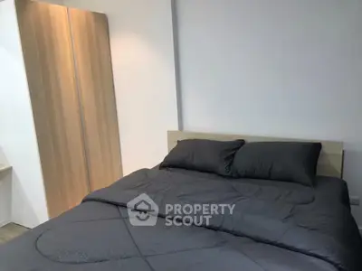 Modern bedroom with sleek wooden wardrobe and cozy bedding
