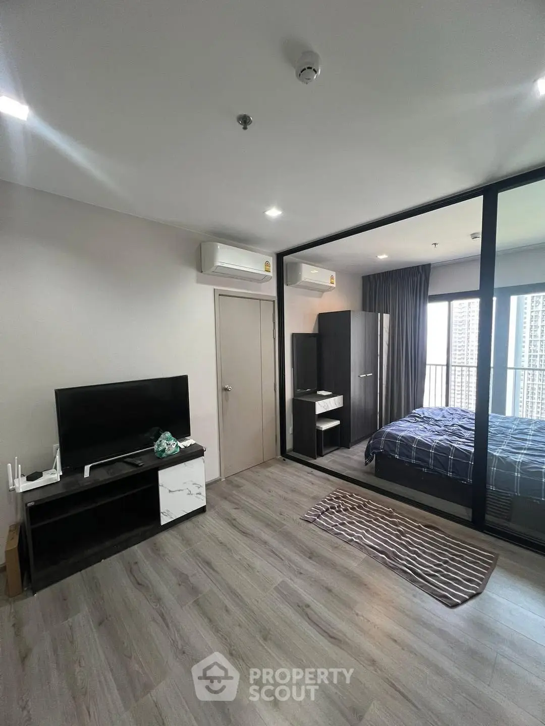 Modern studio apartment with glass partition and sleek flooring