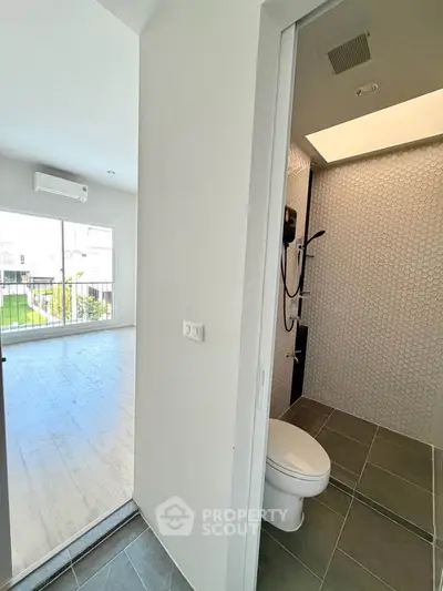 Modern apartment interior with bathroom and bright living area view