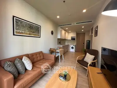 Modern living room with stylish furniture and open kitchen layout in a cozy apartment.