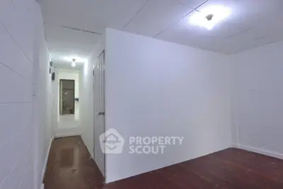 Spacious interior with white walls and wooden flooring, ideal for customization.