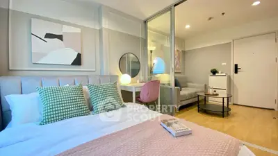 Modern bedroom with stylish decor and cozy living area in open layout apartment.