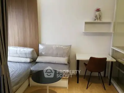 Cozy studio apartment with modern furnishings and a compact workspace.