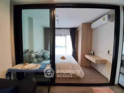 Modern bedroom with glass partition and cozy decor in stylish apartment