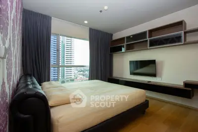 Modern bedroom with city view, stylish shelving, and wall-mounted TV in a high-rise apartment.