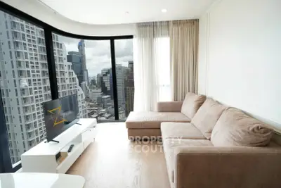 Luxurious living room with panoramic city views and modern furnishings.