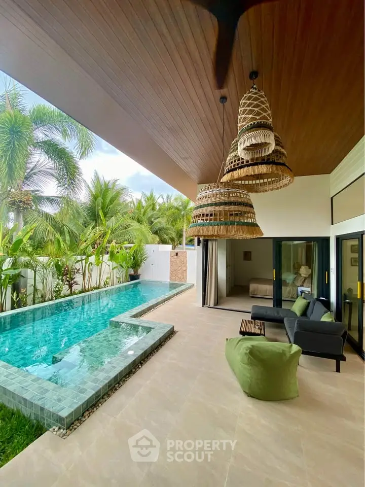 Luxurious tropical villa with private pool and stylish outdoor seating area, perfect for relaxation.