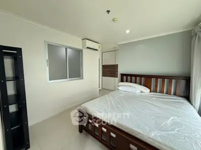 Spacious bedroom with modern furnishings and natural light