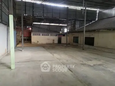 Spacious industrial warehouse with high ceilings and ample storage space.