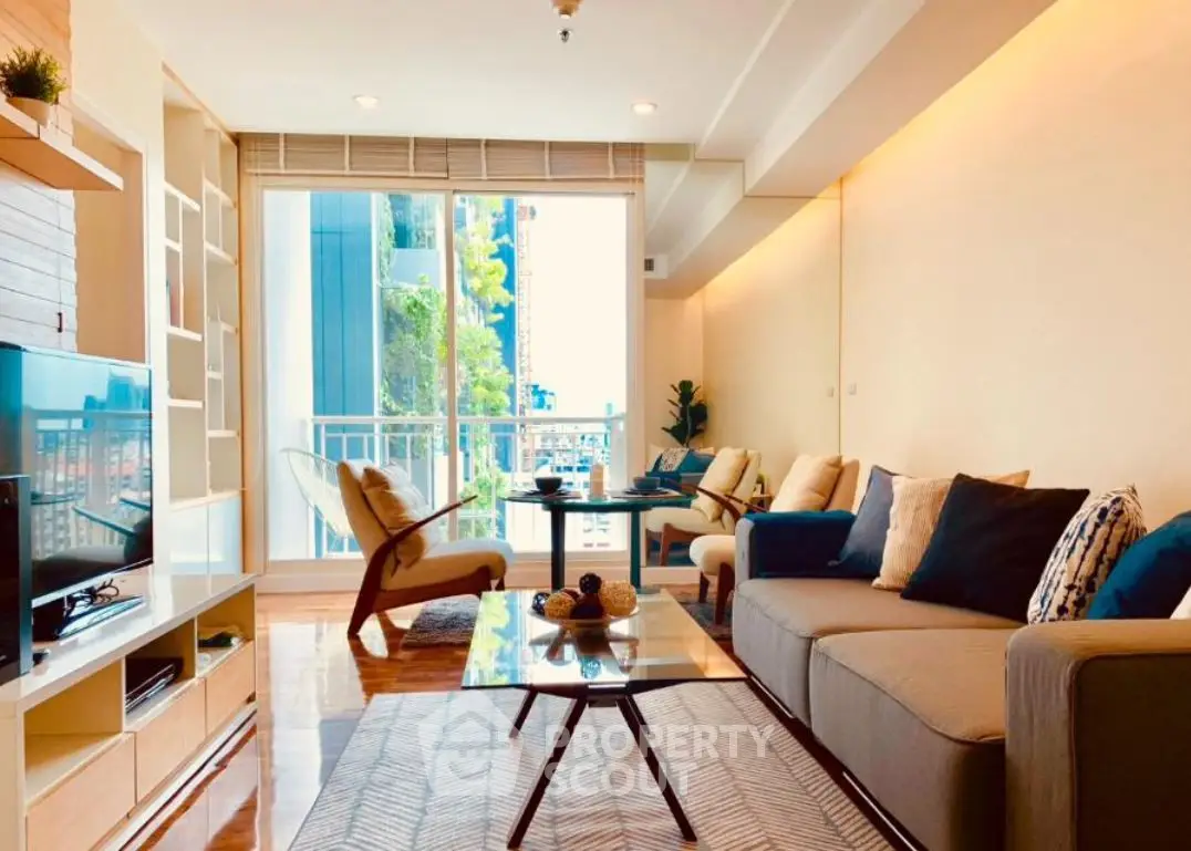 Spacious modern living room with stylish decor and city view balcony.
