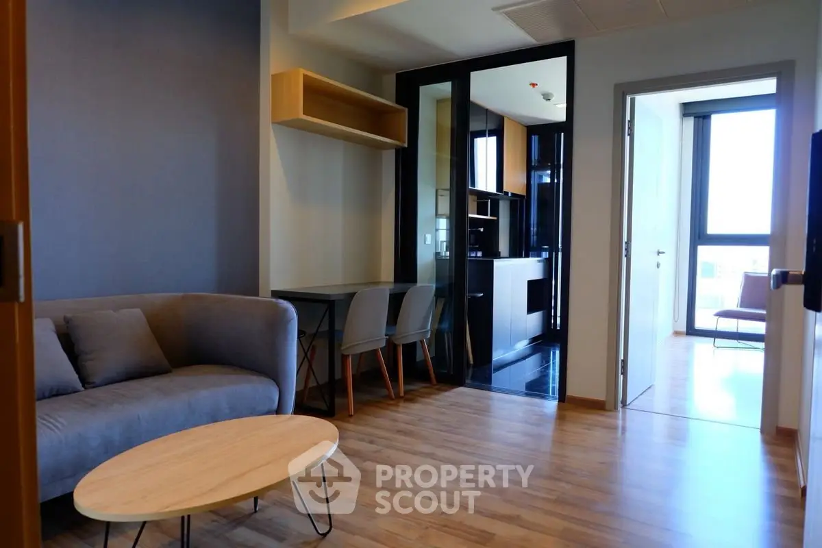 Modern living room with cozy sofa and wooden flooring in stylish apartment