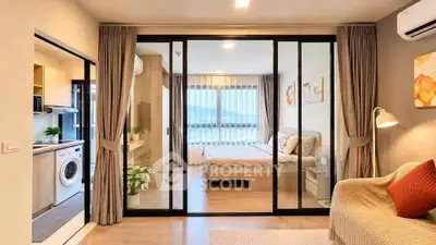 Modern apartment interior with open living room, kitchen, and bedroom featuring large windows and stylish decor.
