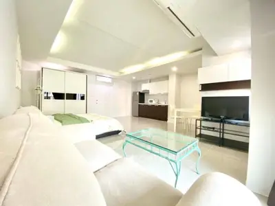 Spacious modern living room with open kitchen and stylish furnishings