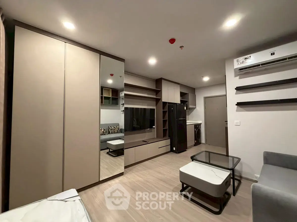 Modern living room with sleek furniture and built-in storage solutions.