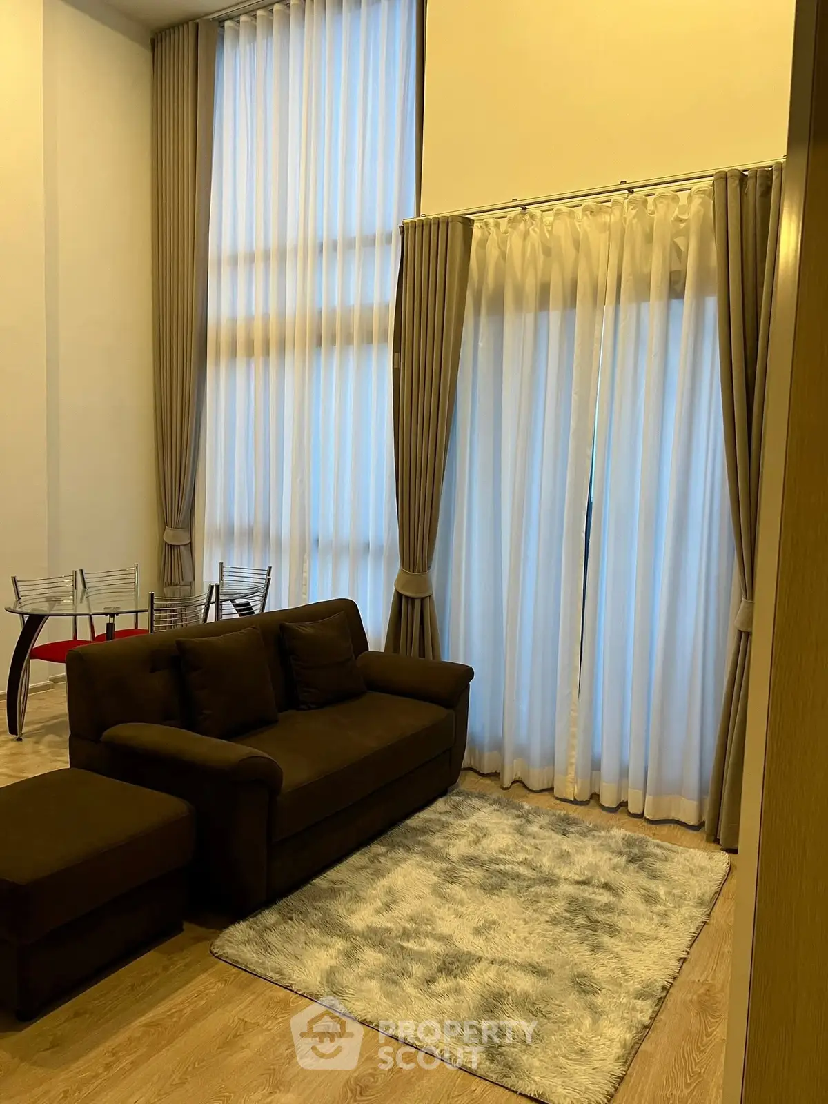 Luxurious living room with high ceilings and elegant curtains