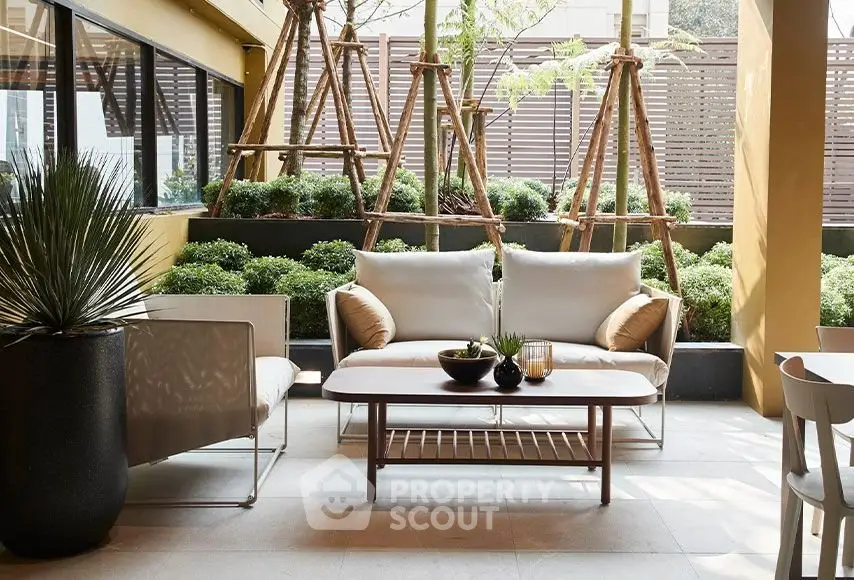 Chic outdoor patio with modern seating and lush greenery, perfect for relaxation and entertaining.