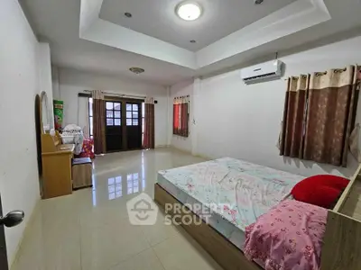 Spacious bedroom with modern decor and natural light