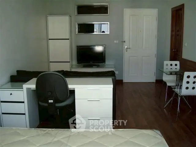 Modern studio apartment with sleek furniture and hardwood floors