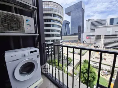 Modern urban balcony with washing machine and cityscape view